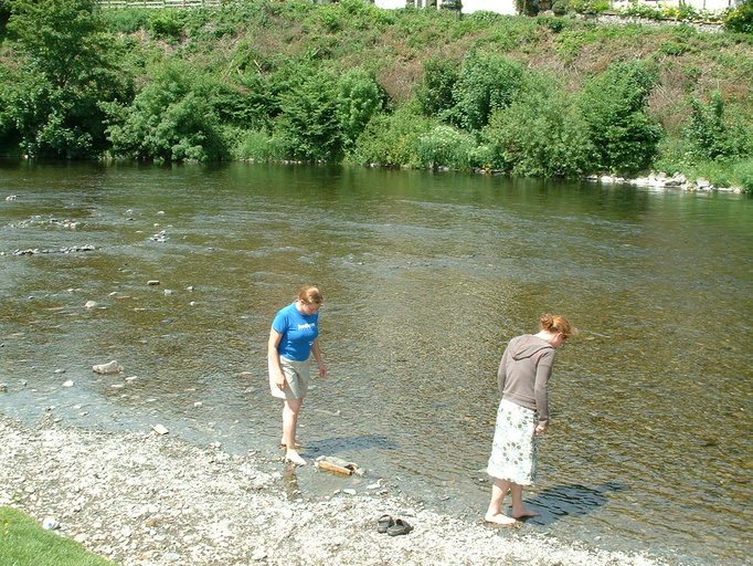 Heidi and Rach paddling in river at Carrog