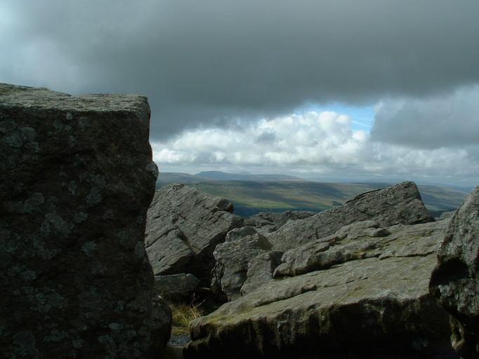 View from Great Whernside summit with Pen-y-ghent, Ingleborough and Whernside in the distance