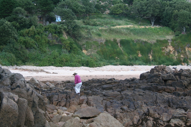 Sandy clambering over rocks to reach the beach